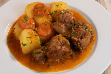Navarin Lamb Shank Stew on wood table and and potatoes, High quality photo