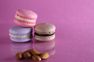 Macaroon cooking result in Fratsuz dessert and almond nuts on a pink background with a place for text and copyspace