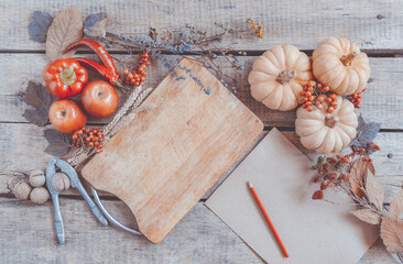 Autumn background, fallen leaves, fruits, vegetables on rustic wooden table. Seasonal set, aged vintage paper, copy space. Thanksgiving food, healthy and fresh, top view, flat lay.