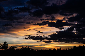Panorama Cityscape at sunset with large river at foreground and strom clouds at background in...