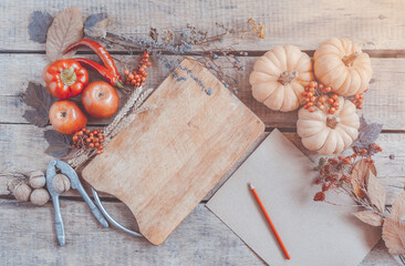 Autumn background, fallen leaves, fruits, vegetables on rustic wooden table. Seasonal set, aged vintage paper, copy space. Thanksgiving food, healthy and fresh, top view, flat lay.