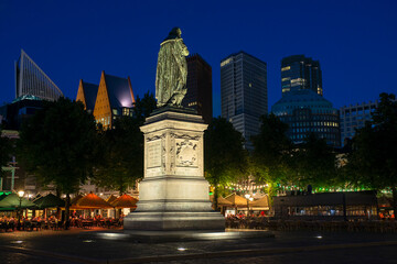 Statue of Willem de Zwijger on het Plein in The Hague, Holland, with the skyline of the city visible in the background