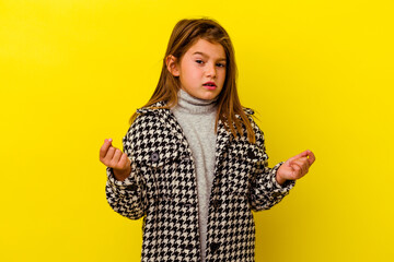 Little caucasian girl isolated on yellow background showing that she has no money.