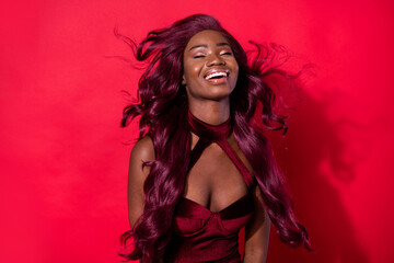 Photo of beautiful young afro american woman fly wind hair party dress isolated on red color background