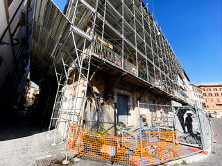 An ancient building undergoing renovation covered with steel scaffolding.