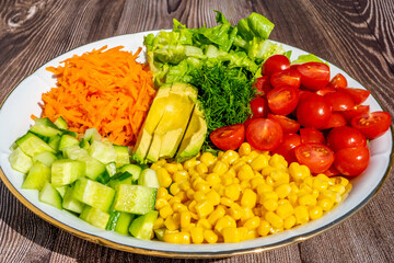Salad ingredients Carrot, Avocado, Cucumber, Corn, Cherry Tomatoes. Healthy Vegetarian Food
