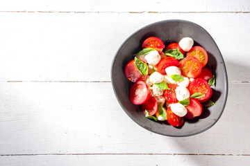 Tomato mozzarella Caprese salad with basil and olive oil. Mediterranean Italian food concept