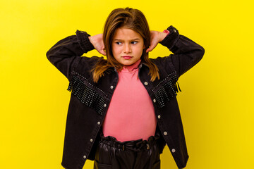Little caucasian girl isolated on yellow background suffering neck pain due to sedentary lifestyle.