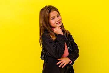 Little caucasian girl isolated on yellow background smiling happy and confident, touching chin with...