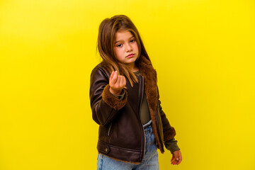 Little caucasian girl isolated on yellow background showing that she has no money.