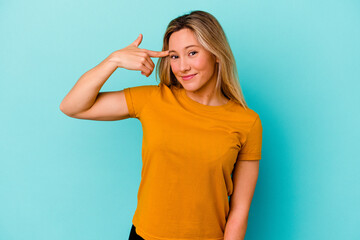 Young mixed race woman isolated on blue background showing a disappointment gesture with forefinger.