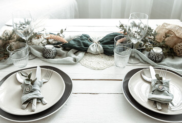 Stylish table setting for two with decor details.