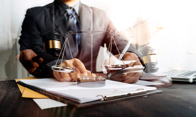 Business and lawyers discussing contract papers with brass scale on desk in office. Law, legal services, advice, justice and law concept picture with film grain effect