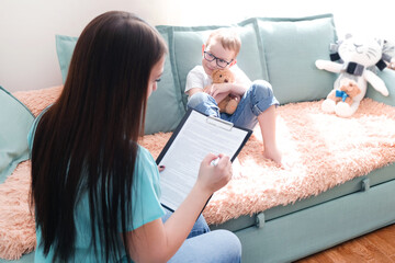 boy in a psychologist's office. Psychologist talking to a child