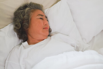 Asian Elderly woman sleep and sweet dream on bed.