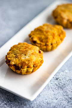 Savoury meat pies with cheese on a plate