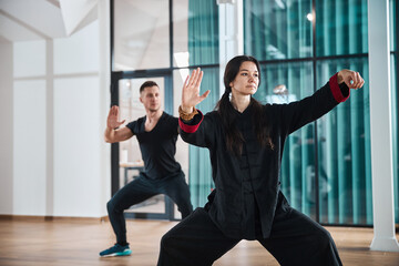 Woman giving a tai chi lesson indoors