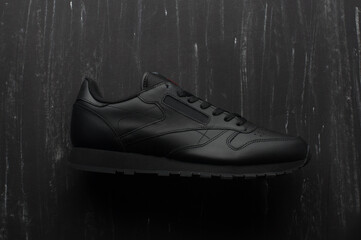 Men black sports sneakers on a dark background