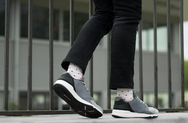 Gray sneakers  on a city background