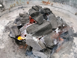 Macro view of burning coal embers bonfire, detail of coal texture