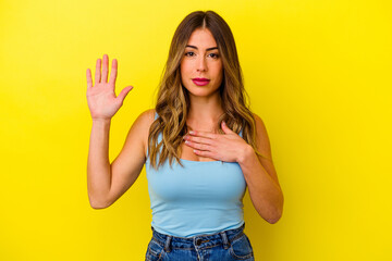 Young caucasian woman isolated on yellow background