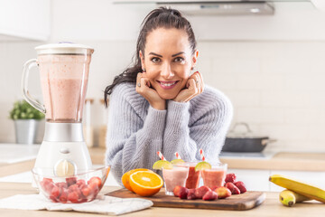 Fruit-based diet made by a woman at home through mixing berries and citruses into a smoothie