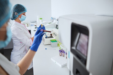 Scientist examining a test tube with a whole blood sample