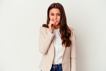 Young Indian business woman isolated on white background biting fingernails, nervous and very anxious.