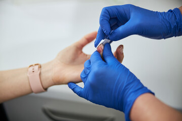 Lab worker conducting a medical procedure on the patient
