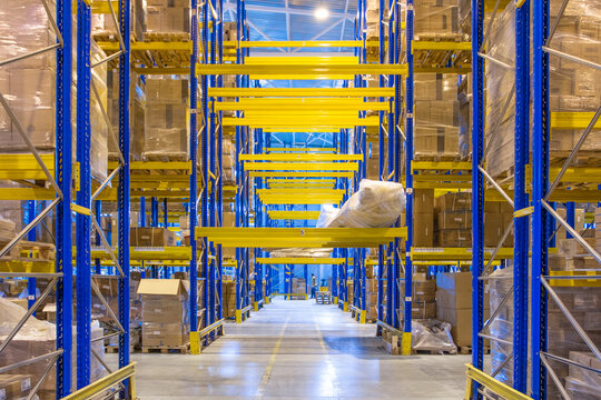 Interior of a modern warehouse storage with rows and goods boxes on high shelves
