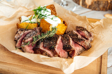 Closeup on roasted beef meat with potato and sour cream
