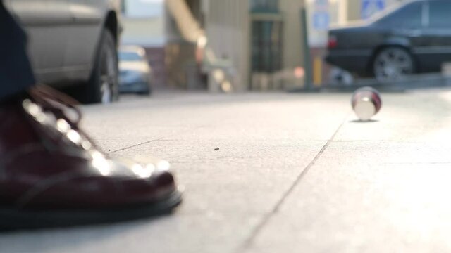 Annoyed obscene citizen kicks a paper cup in a public place
