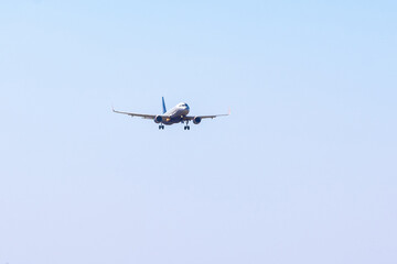 Fototapeta na wymiar Passenger airplane flying against clear blue sky