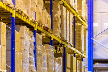 Interior of a modern warehouse storage with rows and goods boxes on high shelves