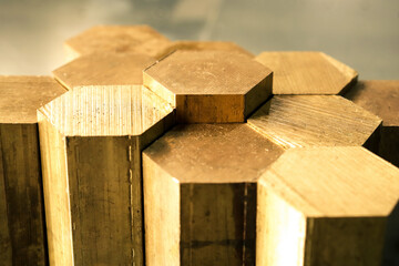 Hexagon made of brass sawn into blanks for further processing on a metalworking machine. Metal...
