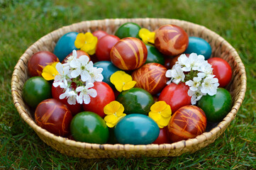 Fototapeta na wymiar basket of colorful Easter eggs lying in the grass