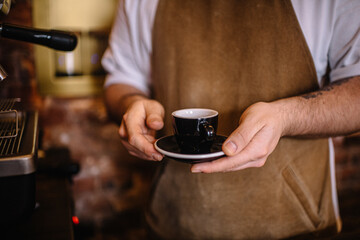 Fototapeta na wymiar Person holding a cup of espresso coffee.