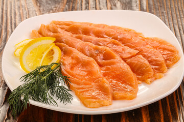 Sliced salted salmon with lemon