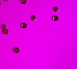 Purple background paper with sequin decor. Contrast and minimalism concept.