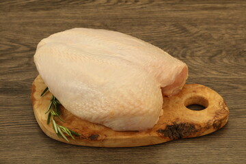 Raw whole chicken breast with skin