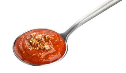Spoon with tomato soup isolated on white background