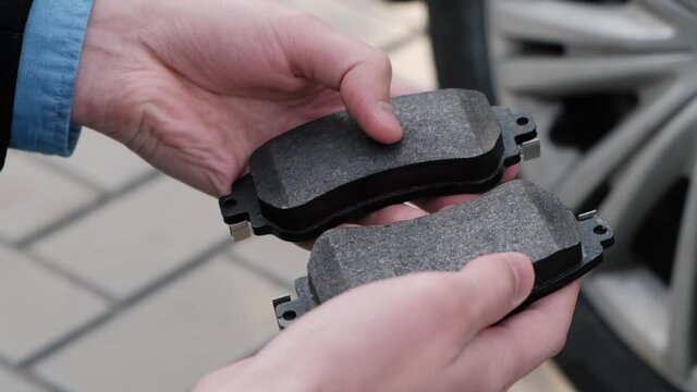New brake pads in the hands of the driver or service worker