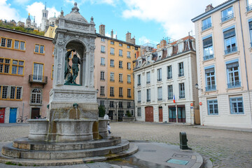 Lyon, France - August 25, 2019: Sculpture and fountain near Cathedrale Saint-Jean-Baptiste