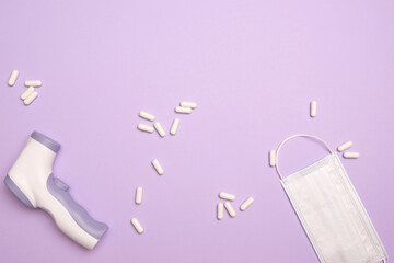 Non-contact infrared thermometer. Body Temperature Measurement Device. White capsule pills and...