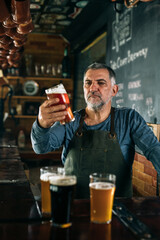barman serving lager in bar