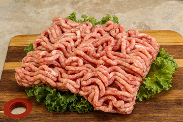 Raw pork minced meat over board