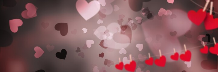 Red heart shapes on a string against grey background