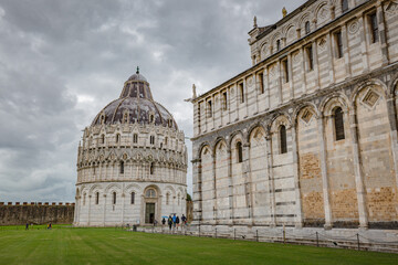 View of The Pisa Baptistery and The Pisa Cathedral (Duomo di Pisa) on Piazza dei Miracoli in Pisa, Tuscany, Italy.
