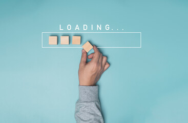 Hand putting wooden cube block with infographic for download on blue background , Technology and...
