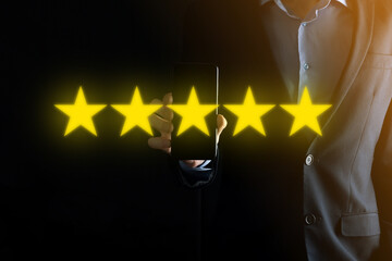 Man hand showing on five star excellent rating.pointing five star symbol to increase rating of company.Review, increase rating or ranking, evaluation and classification concept